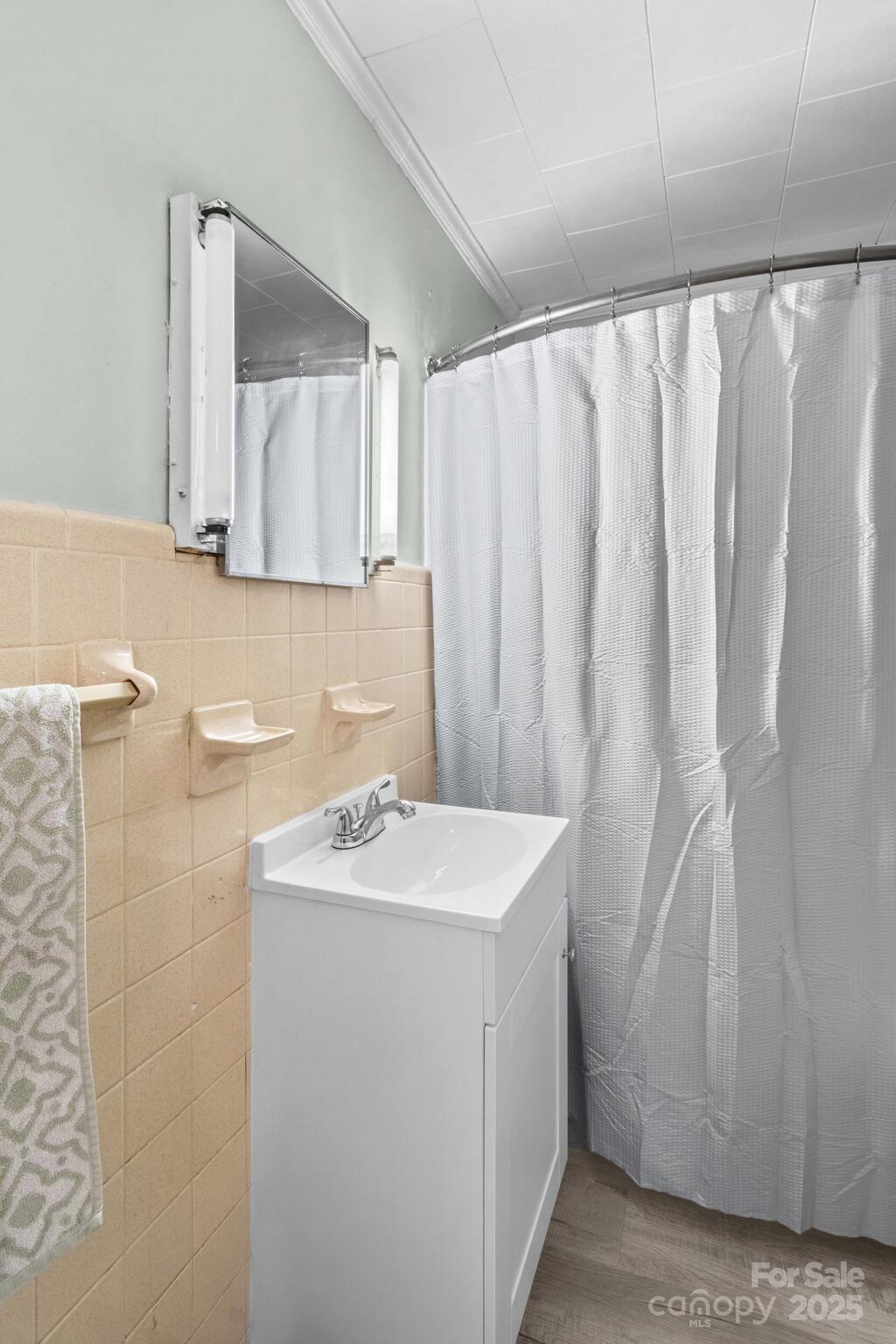 185 Homer Corriher Road China Grove, NC 28023 - Photo 25 of 48 a bathroom with a sink a mirror and a shower curtain