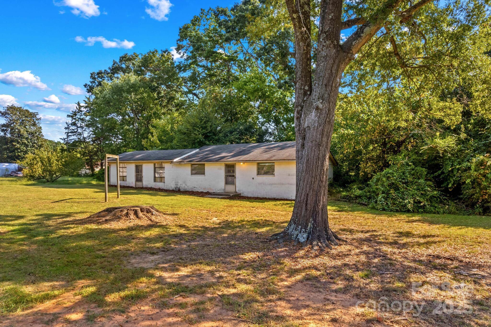 185 Homer Corriher Road China Grove, NC 28023 - Photo 45 of 48 a blue swimming pool is in front of a house