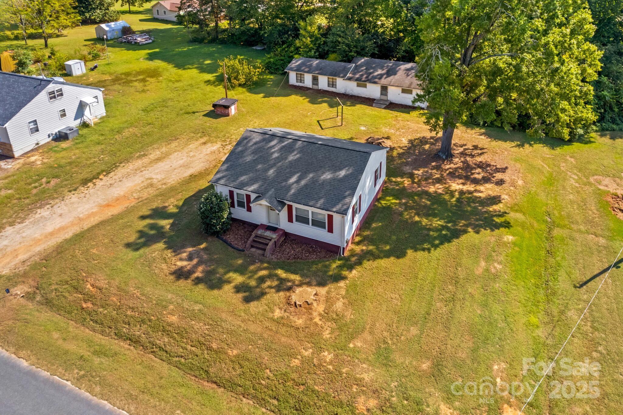185 Homer Corriher Road China Grove, NC 28023 - Photo 7 of 48 an aerial view of a house with a swimming pool