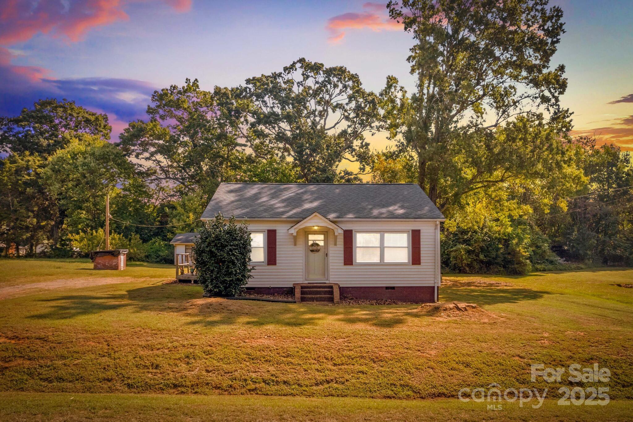 185 Homer Corriher Road China Grove, NC 28023 - Photo 9 of 48 a front view of a house with a yard and a large tree