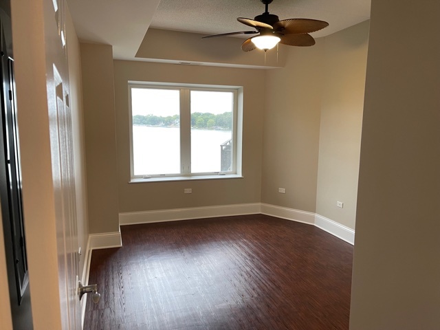 728 North Diamond Lake Road, Unit 405 Mundelein, IL 60060 - Photo 15 of 19 a view of an empty room with wooden floor and a window