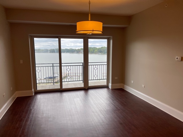 728 North Diamond Lake Road, Unit 405 Mundelein, IL 60060 - Photo 9 of 19 a view of a room with wooden floor and windows