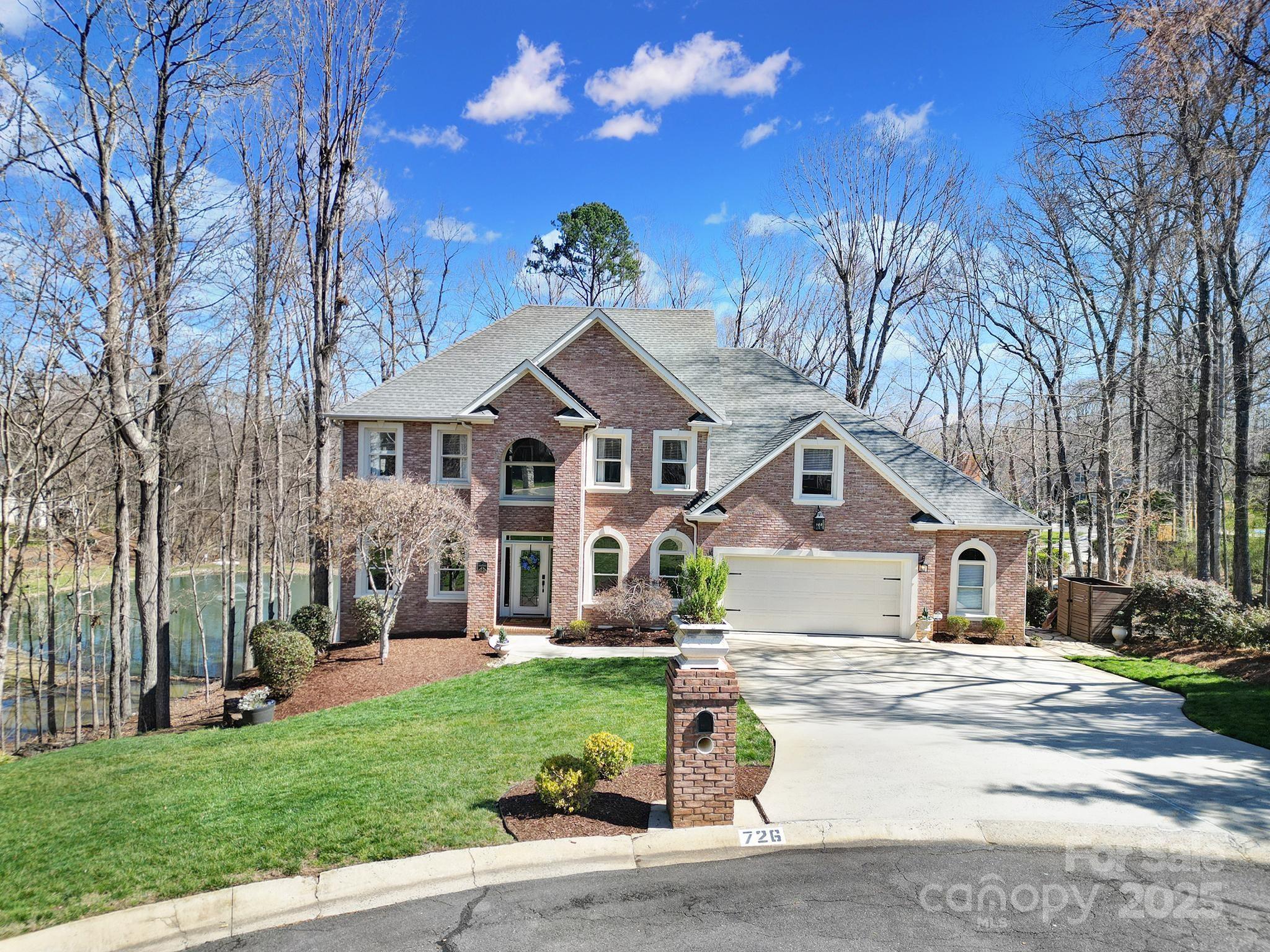 726 Amberly Crossing Fort Mill, SC 29708 - Photo 1 of 47 a front view of a house with a garden and trees