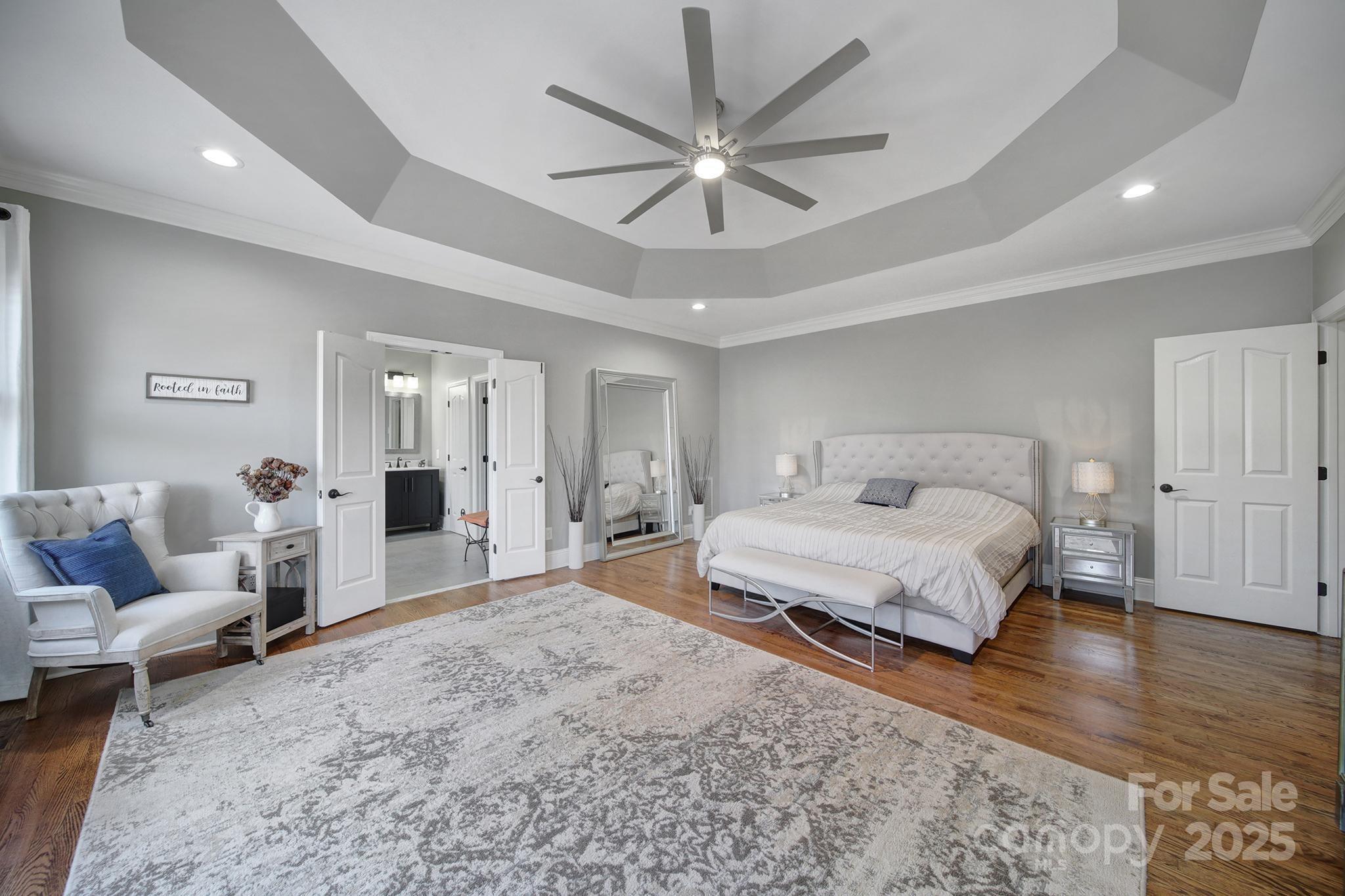 726 Amberly Crossing Fort Mill, SC 29708 - Photo 17 of 47 a spacious bedroom with a bed a window and a couch
