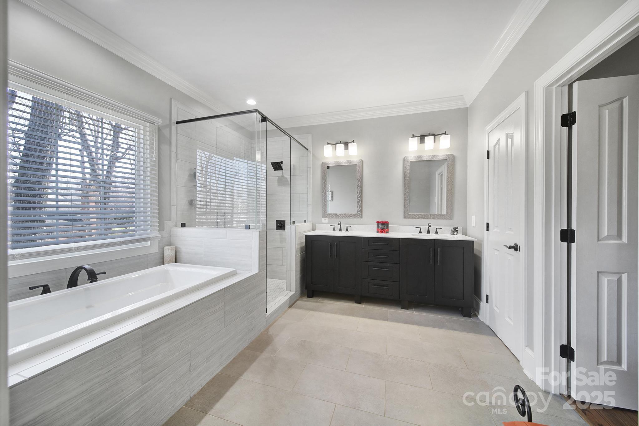 726 Amberly Crossing Fort Mill, SC 29708 - Photo 18 of 47 a bathroom with a tub a sink and mirror