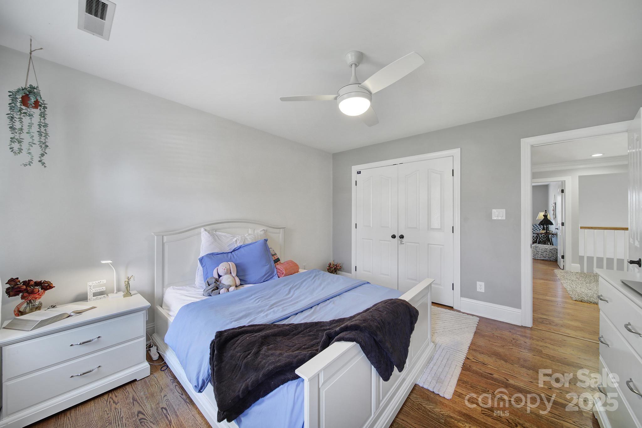 726 Amberly Crossing Fort Mill, SC 29708 - Photo 24 of 47 a bedroom with a bed and a chandelier