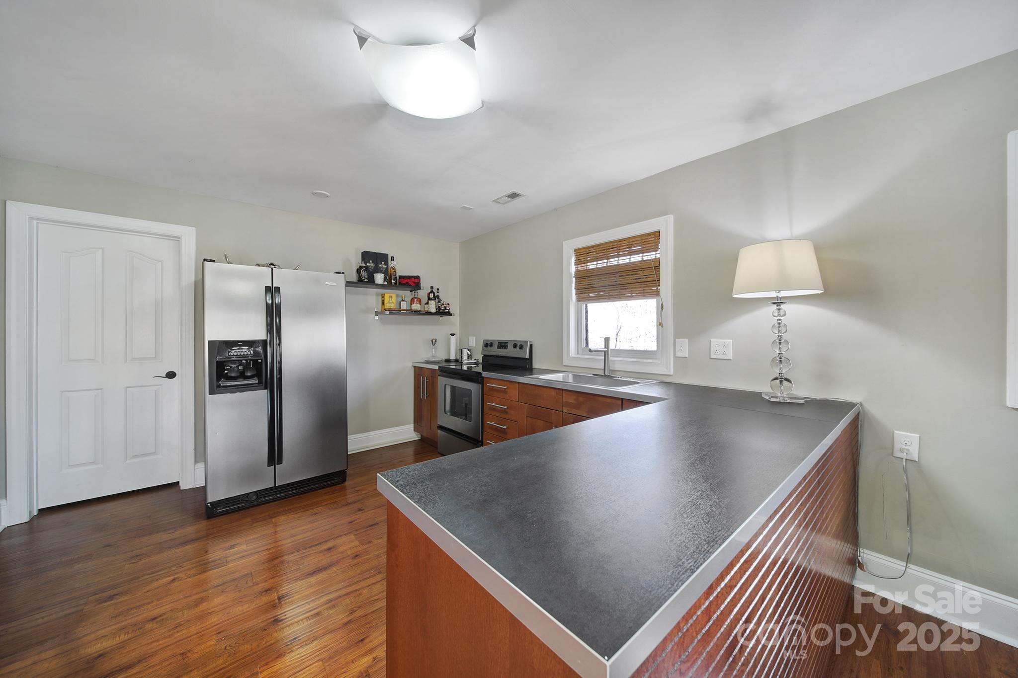 726 Amberly Crossing Fort Mill, SC 29708 - Photo 42 of 47 a kitchen with stainless steel appliances granite countertop a sink a stove and a refrigerator