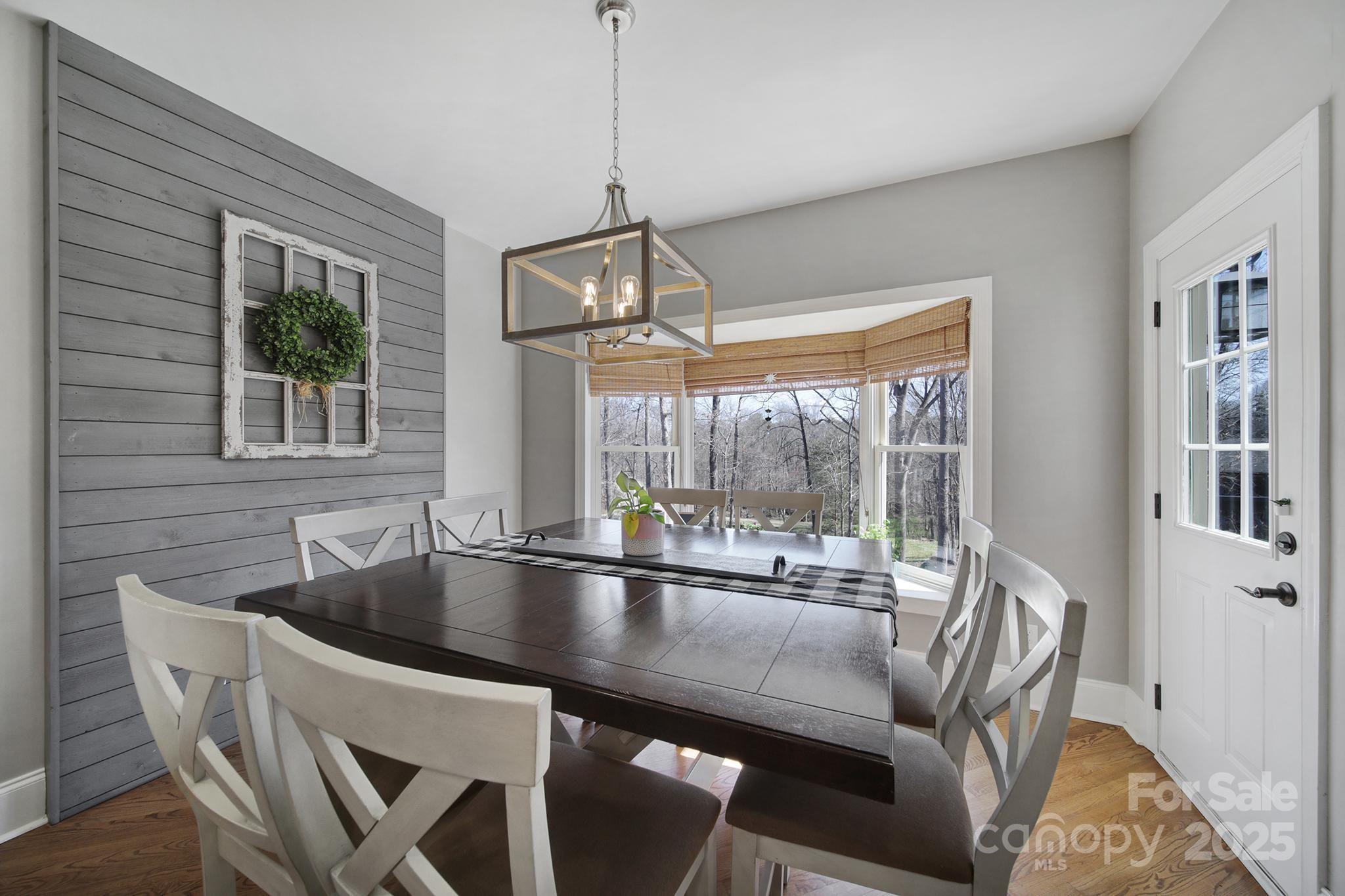 726 Amberly Crossing Fort Mill, SC 29708 - Photo 9 of 47 a dining room with furniture a chandelier and wooden floor