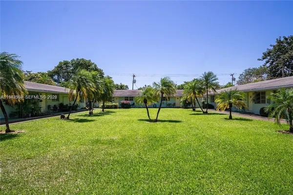 a swimming pool with lots of tress in front of it