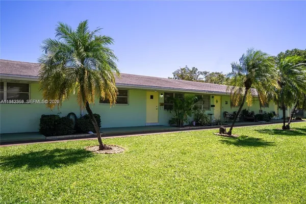 a house with palm tree in front of it