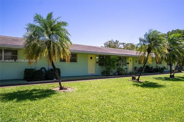 a house with palm tree in front of it