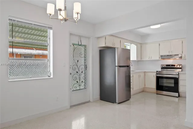 a kitchen with stainless steel appliances a refrigerator and a stove top oven