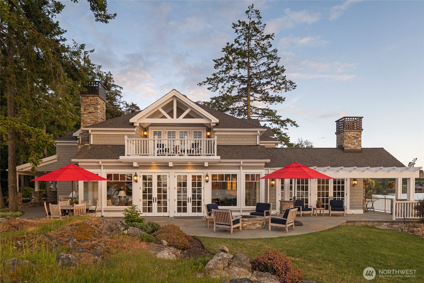 95 Laurel Point Lane Friday Harbor, WA 98250 - Photo 7 of 40 a patio with a table and chairs under an umbrella