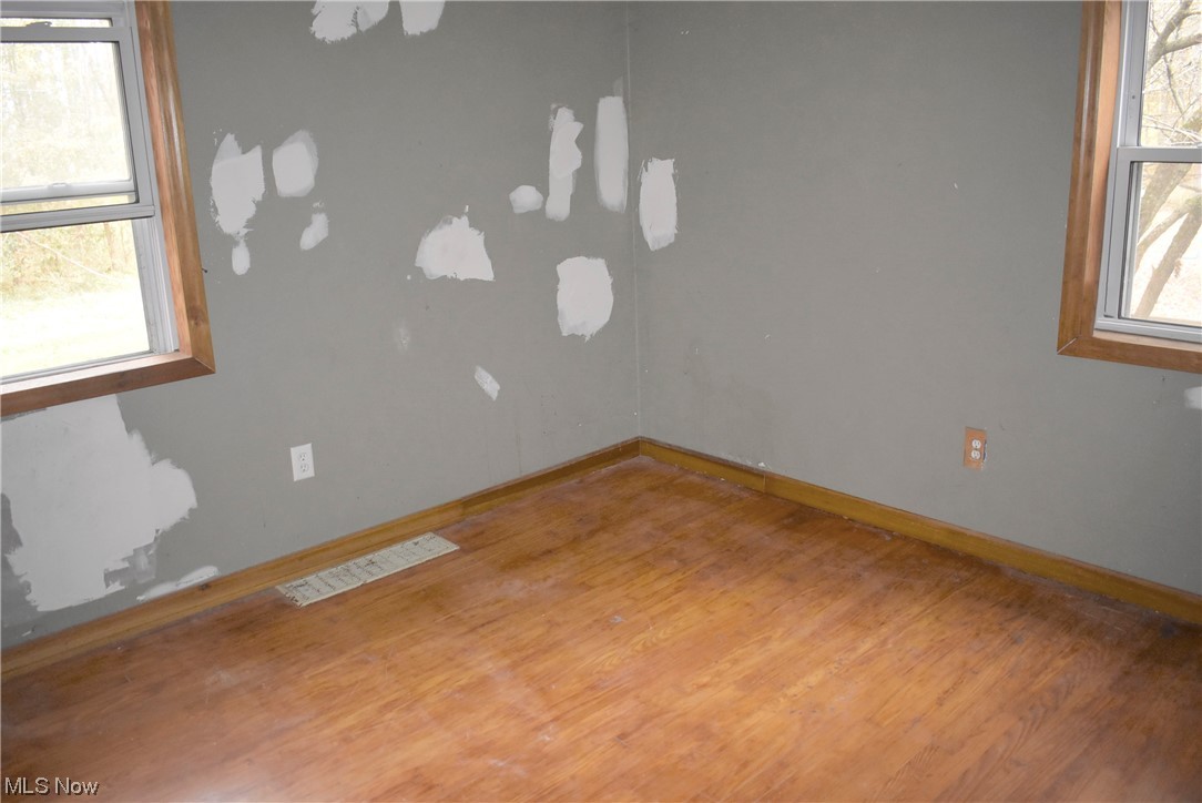 8718 Freedom Road Windham, OH 44288 - Photo 11 of 20 Unfurnished room with plenty of natural light and wood-type flooring