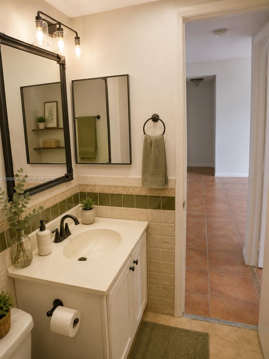 8050 West McNab Road, Unit 206 Tamarac, FL 33321 - Photo 23 of 37 a bathroom with a sink and a mirror