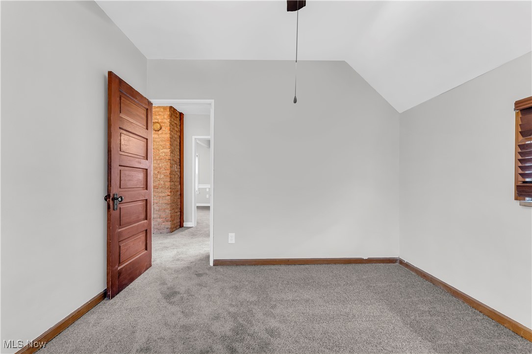 3374 Fulton Road Cleveland, OH 44109 - Photo 16 of 27 Unfurnished room with light colored carpet and lofted ceiling