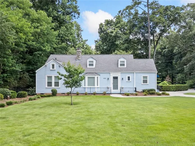 a front view of house with yard and green space