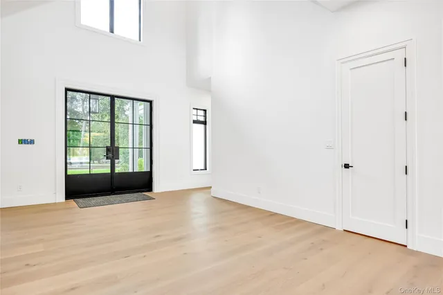 a view of an empty room with a fireplace and a window