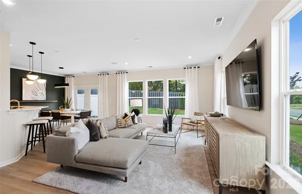 a living room with furniture and large windows
