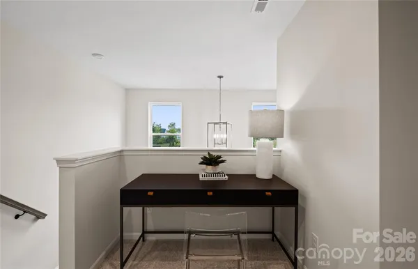 a room with a table chairs and a window
