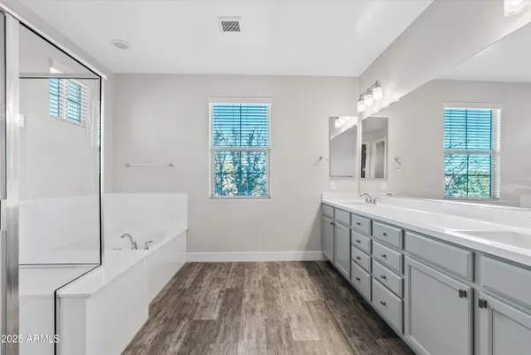 a bathroom with a sink mirror and a bathtub