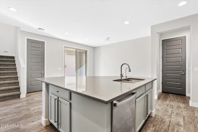 a kitchen with a sink and cabinets