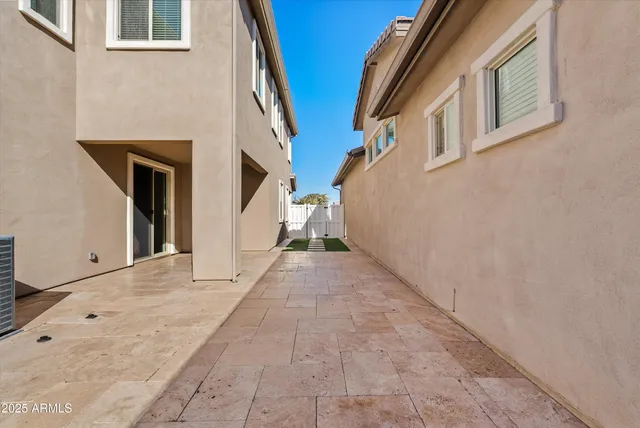 a front view of a house with a yard and potted plants