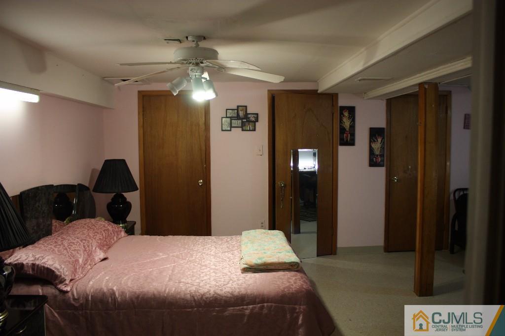 11 Bucknell Road Old Bridge, NJ 08859 - Photo 12 of 16 a bedroom with a bed and a chandelier