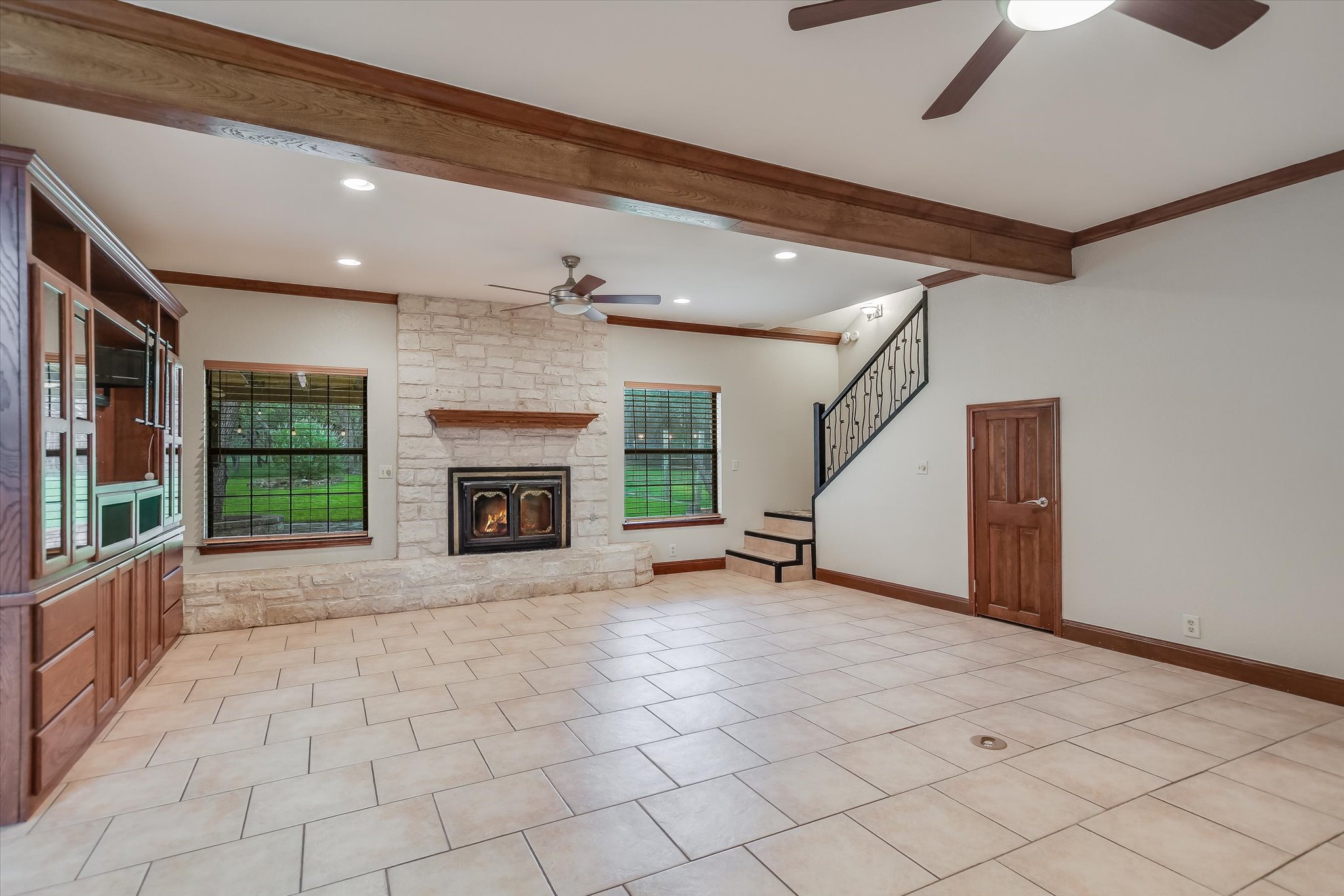 328 Fawnridge Street Georgetown, TX 78628 - Photo 2 of 33 Living room - featuring fresh paint, wood beams, masonry fireplace, built-in shelving and recessed lighting.