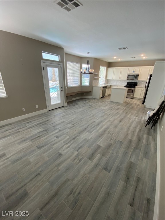 2225 Warm Walnut Drive Las Vegas, NV 89134 - Photo 11 of 38 Unfurnished living room featuring a chandelier, light wood finished floors, and recessed lighting