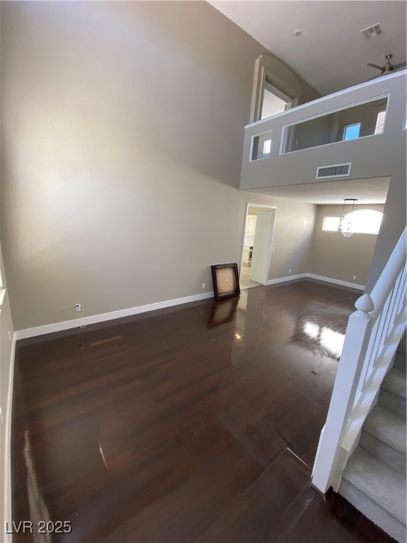 2225 Warm Walnut Drive Las Vegas, NV 89134 - Photo 2 of 38 Unfurnished living room with wood finished floors, a high ceiling, and stairway
