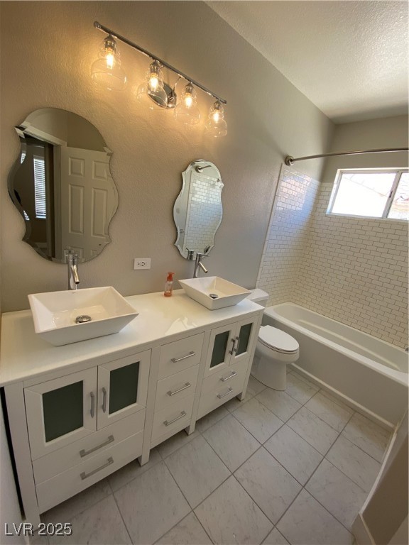 2225 Warm Walnut Drive Las Vegas, NV 89134 - Photo 22 of 38 Bathroom with double vanity, tub / shower combination, and a textured ceiling