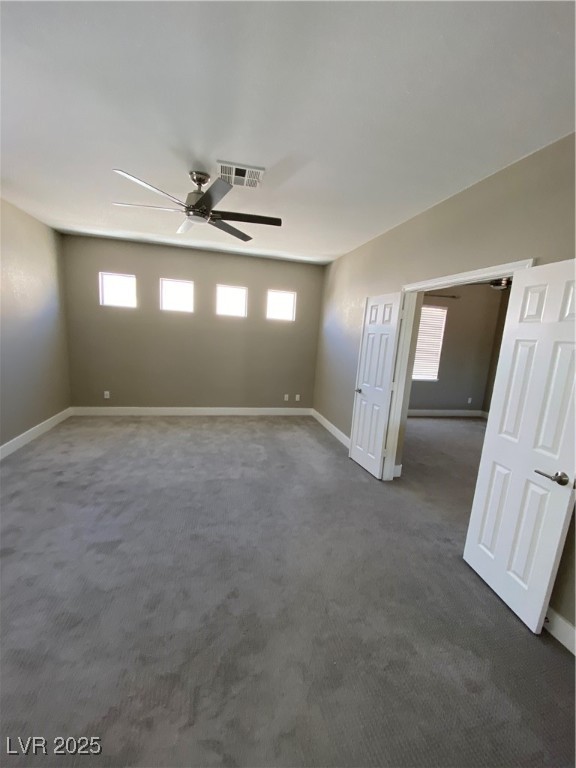 2225 Warm Walnut Drive Las Vegas, NV 89134 - Photo 31 of 38 Empty room featuring healthy amount of natural light, dark colored carpet, and ceiling fan