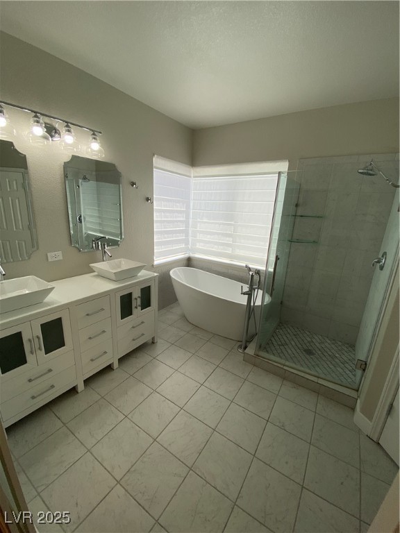 2225 Warm Walnut Drive Las Vegas, NV 89134 - Photo 34 of 38 Bathroom featuring a shower stall, double vanity, a soaking tub, and tile patterned floors