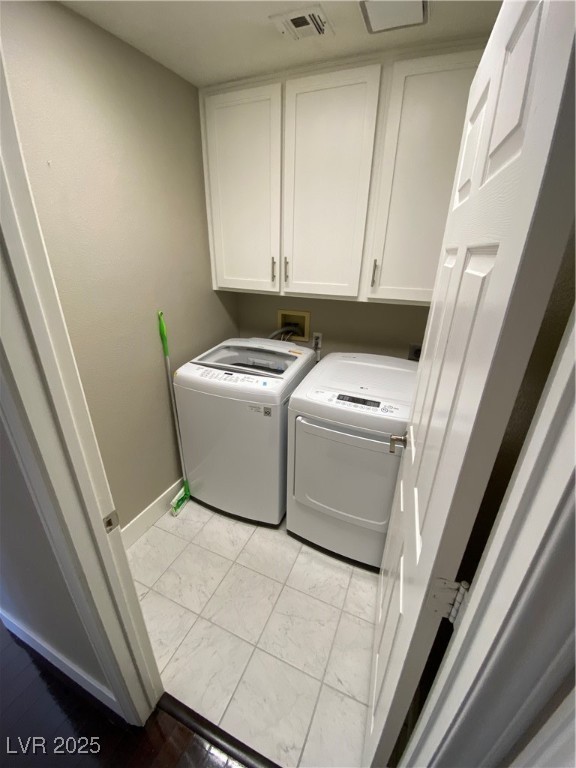 2225 Warm Walnut Drive Las Vegas, NV 89134 - Photo 4 of 38 Laundry area featuring cabinet space, washing machine and dryer, and light marble finish floors