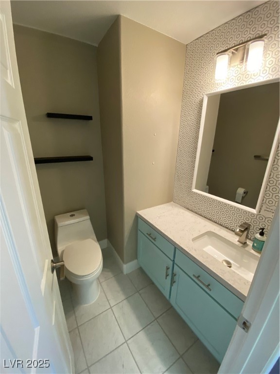 2225 Warm Walnut Drive Las Vegas, NV 89134 - Photo 6 of 38 Half bath featuring vanity, tile patterned flooring, and wallpapered walls