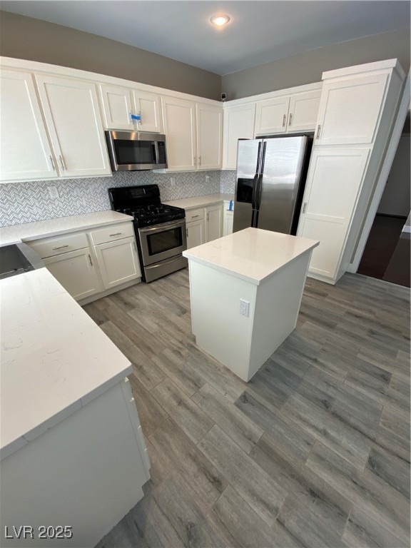 2225 Warm Walnut Drive Las Vegas, NV 89134 - Photo 8 of 38 Kitchen featuring range, fridge, white cabinetry, backsplash, and light countertops