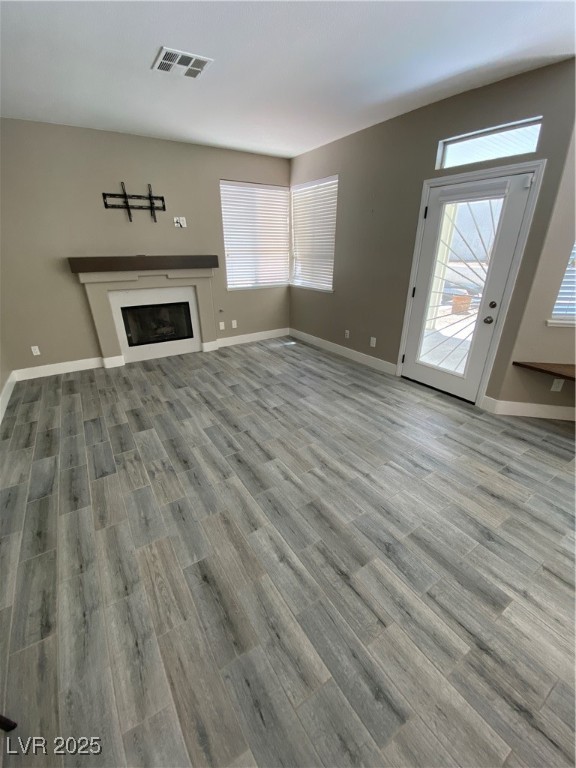 2225 Warm Walnut Drive Las Vegas, NV 89134 - Photo 10 of 38 Unfurnished living room with wood finished floors and a fireplace