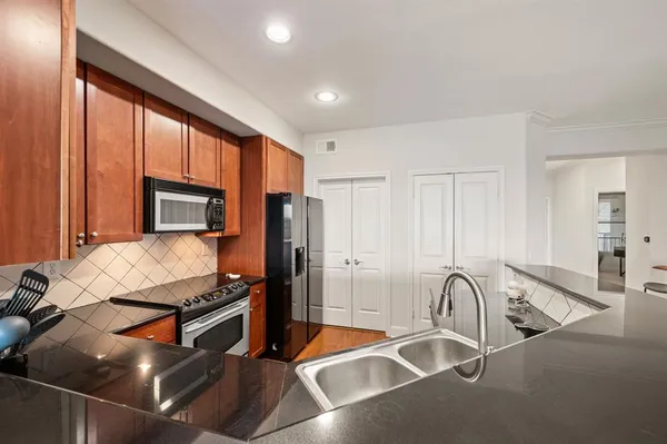 a room with table chairs and a flat screen tv