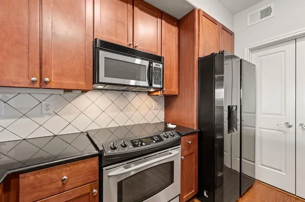 a kitchen with a refrigerator stove and microwave