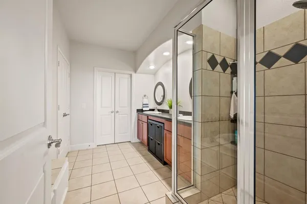 a bathroom with a shower and mirror