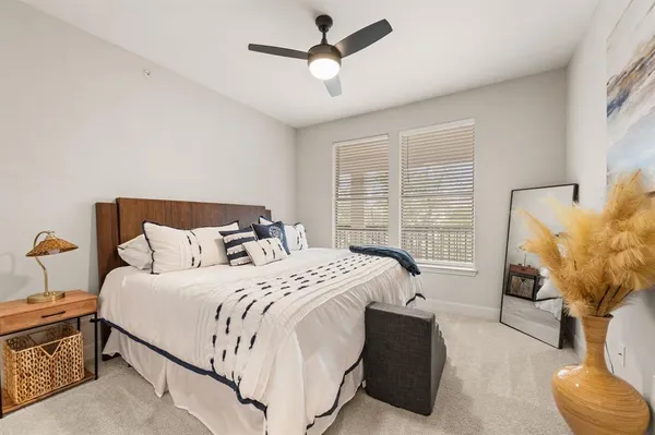 a bedroom with bed couch and window
