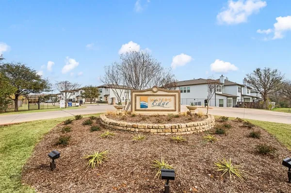 a view of a white house with a yard