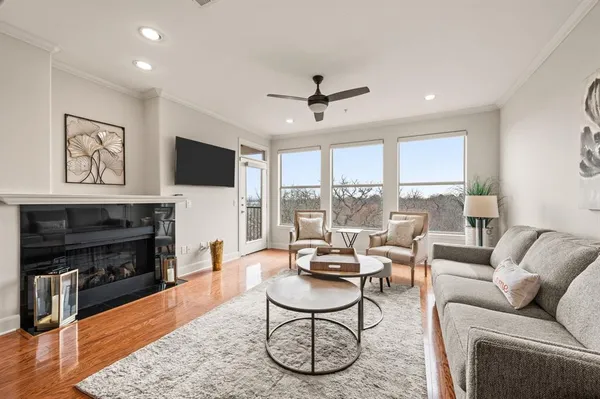 a living room with furniture a fireplace and a flat screen tv