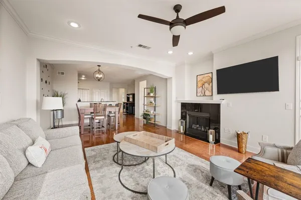 a living room with furniture a fireplace and a flat screen tv