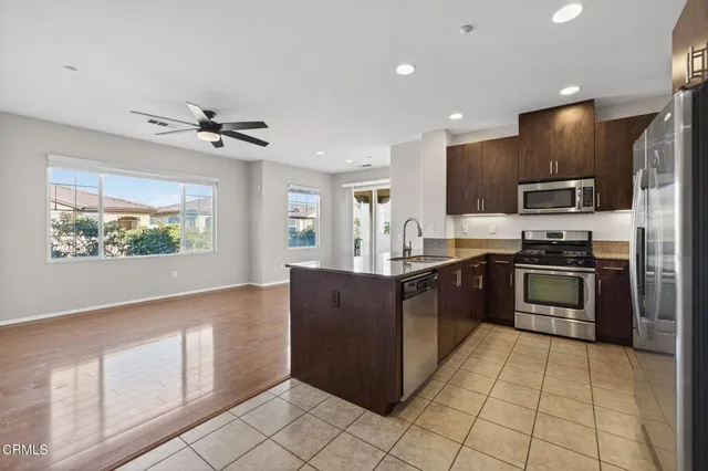 a kitchen with stainless steel appliances granite countertop a refrigerator and a stove