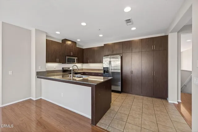 a kitchen with stainless steel appliances granite countertop a sink and cabinets