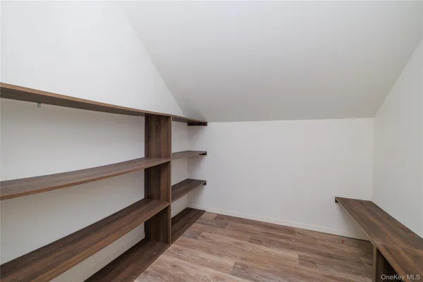 a view of an empty room and wooden floor