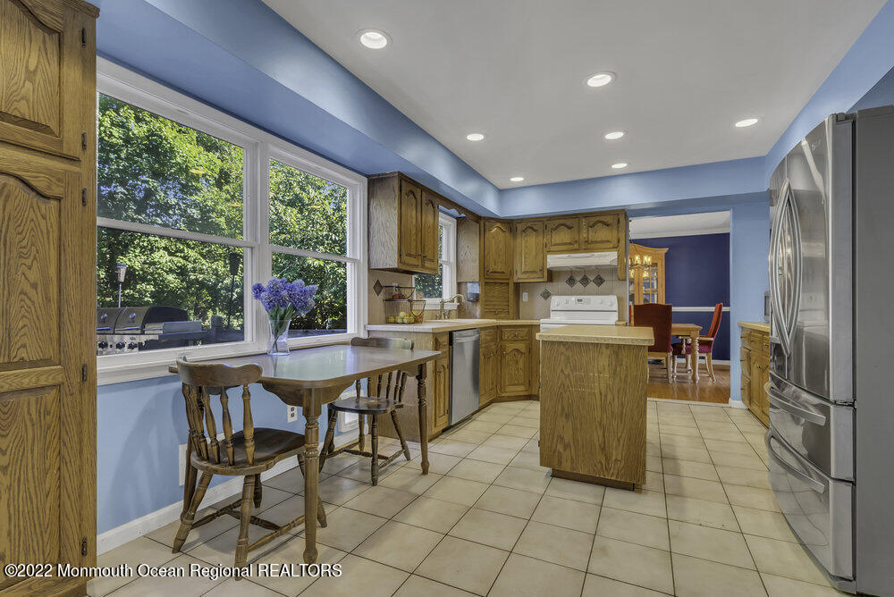 960 Farmingdale Road Jackson, NJ 08527 - Photo 12 of 39 a kitchen with a sink dining table and chairs