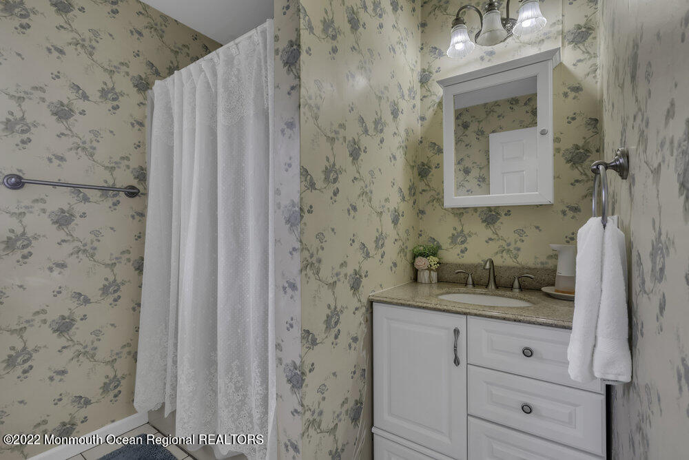 960 Farmingdale Road Jackson, NJ 08527 - Photo 24 of 39 a bathroom with a granite countertop sink and a mirror